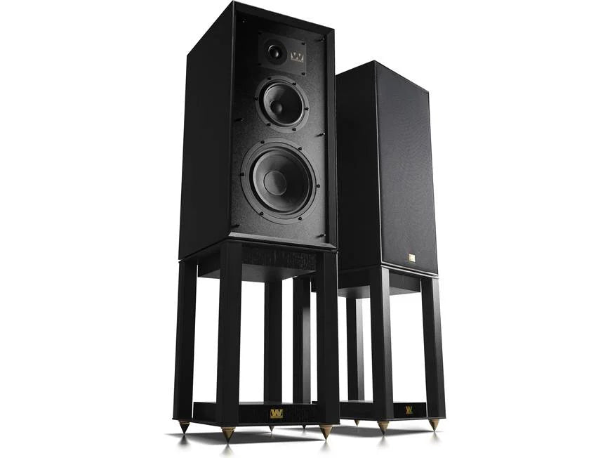 Pair of black speakers on stands against a white background