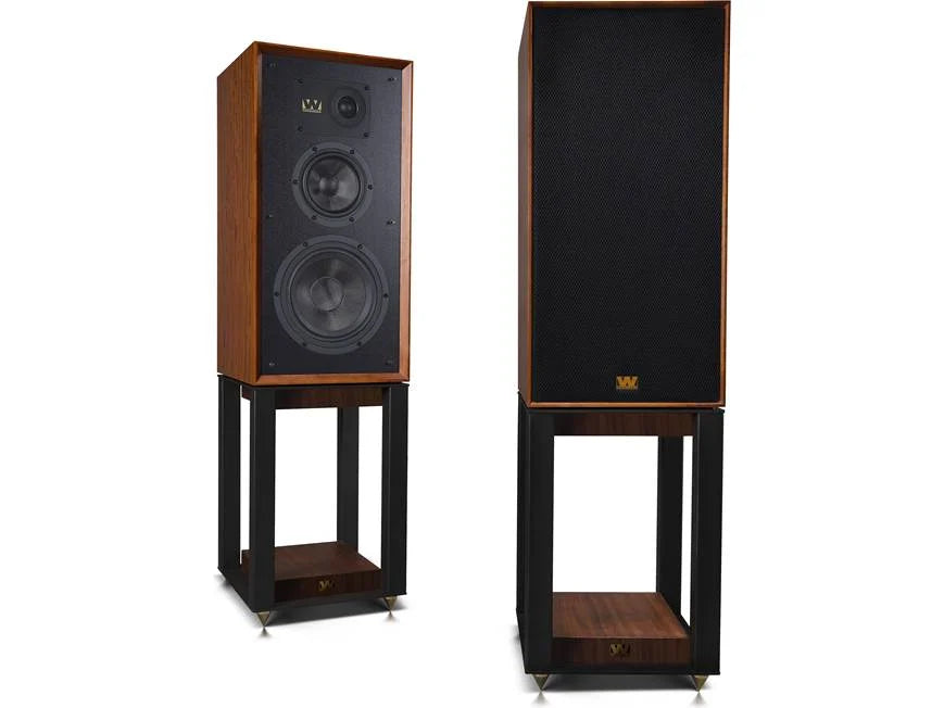 Pair of tall speakers with wooden finish on stands against a white background